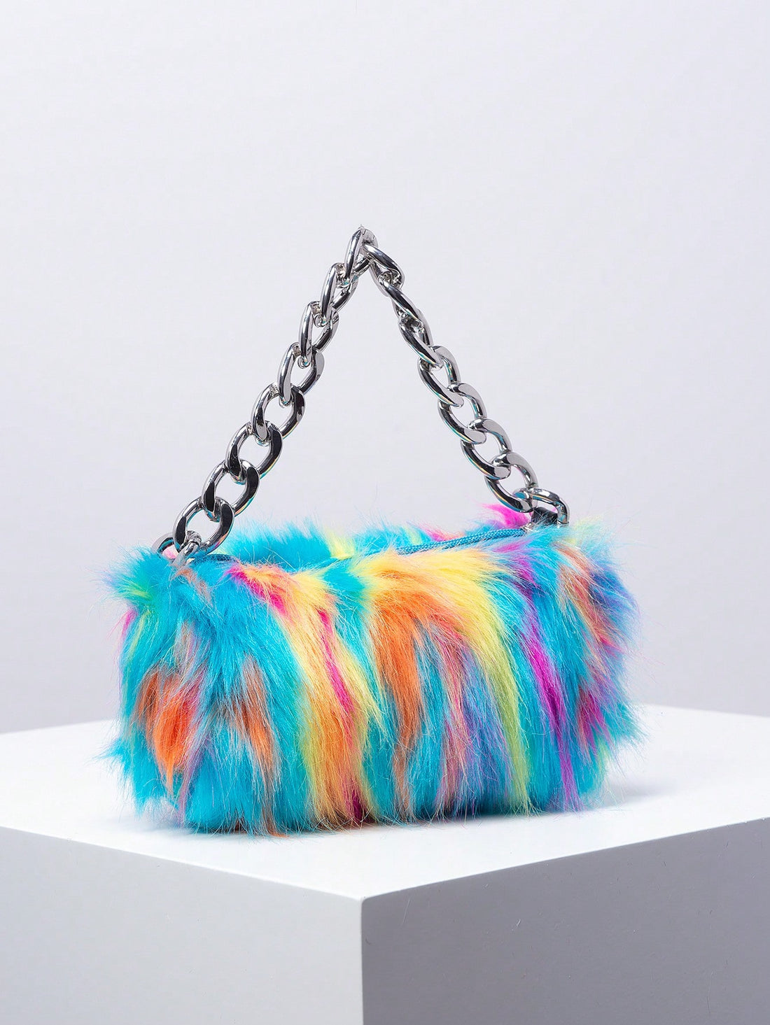 The Rainbow Furry tote is the perfect accessory for trendy girls. With its metal chain and fluffy bucket design, it's both stylish and functional. The rainbow fur adds a fun pop of color, while the metal chain provides durability and convenience. Carry all your essentials in this must-have bag.