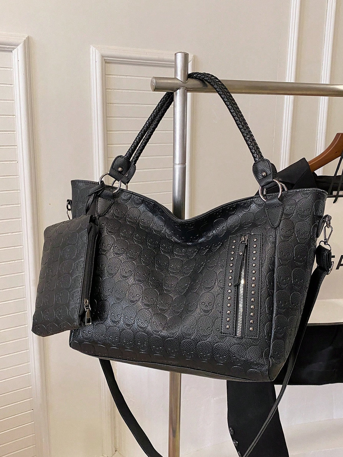 Make a statement with this chic 2-piece tote bag set that's as versatile as your lifestyle. Crafted from sleek black PU leather and adorned with edgy metal studs, this duo delivers serious style for any occasion—whether you're heading to the office, meeting up with friends, or hunting for the perfect gift. The spacious main tote handles everyday essentials with ease, while the compact companion bag keeps your smaller items organized and accessible. Durable, eye-catching, and endlessly practical, this set pr