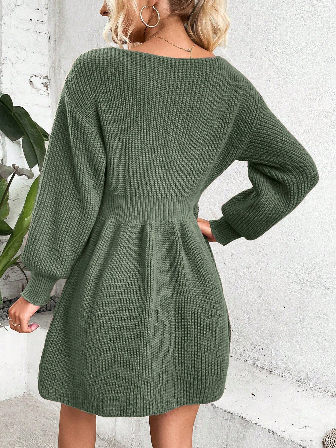 This stylish sweater dress features a chic pearl-accented notched neckline and elegant lantern sleeves. Made with cozy sweater material, it offers a comfortable and flattering fit. Perfect for any occasion, this dress adds a touch of sophistication to your wardrobe.