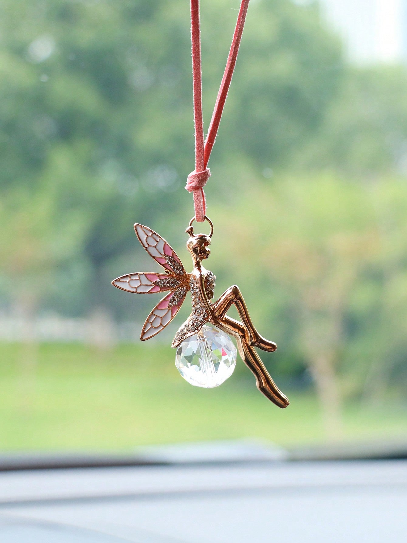 This ornate car hanging ornament features a charming pink crystal flower fairy design that will add a touch of enchantment to your vehicle. Handcrafted with intricate details, it also serves as a unique decorative piece. Elevate your car interior with this stunning addition.