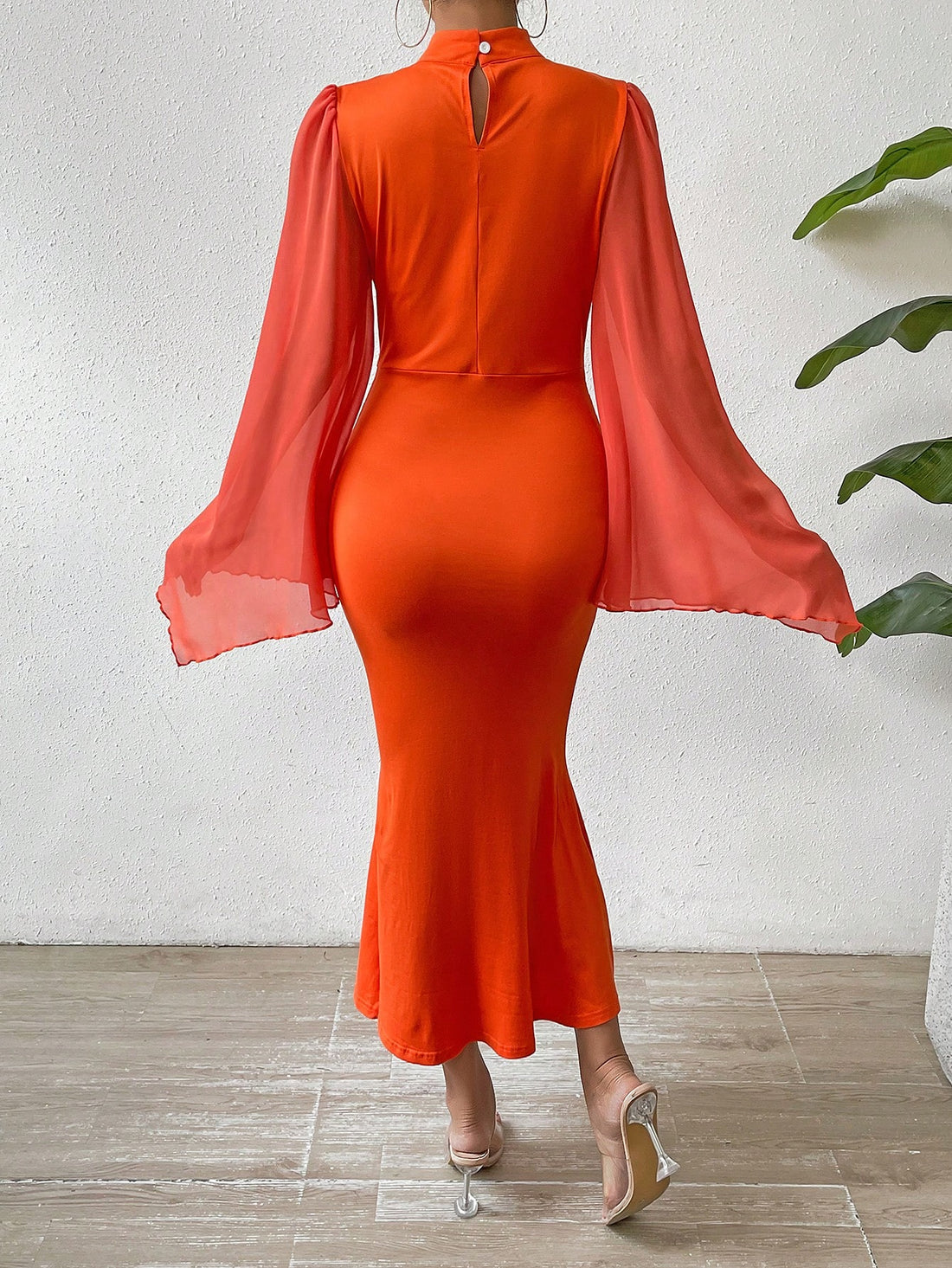 This elegant dress features a mock neck and trumpet sleeves, creating a timeless and sophisticated look. The flattering mermaid silhouette adds a touch of femininity to any occasion. Perfect for formal events or a night out, this dress is sure to make a statement.