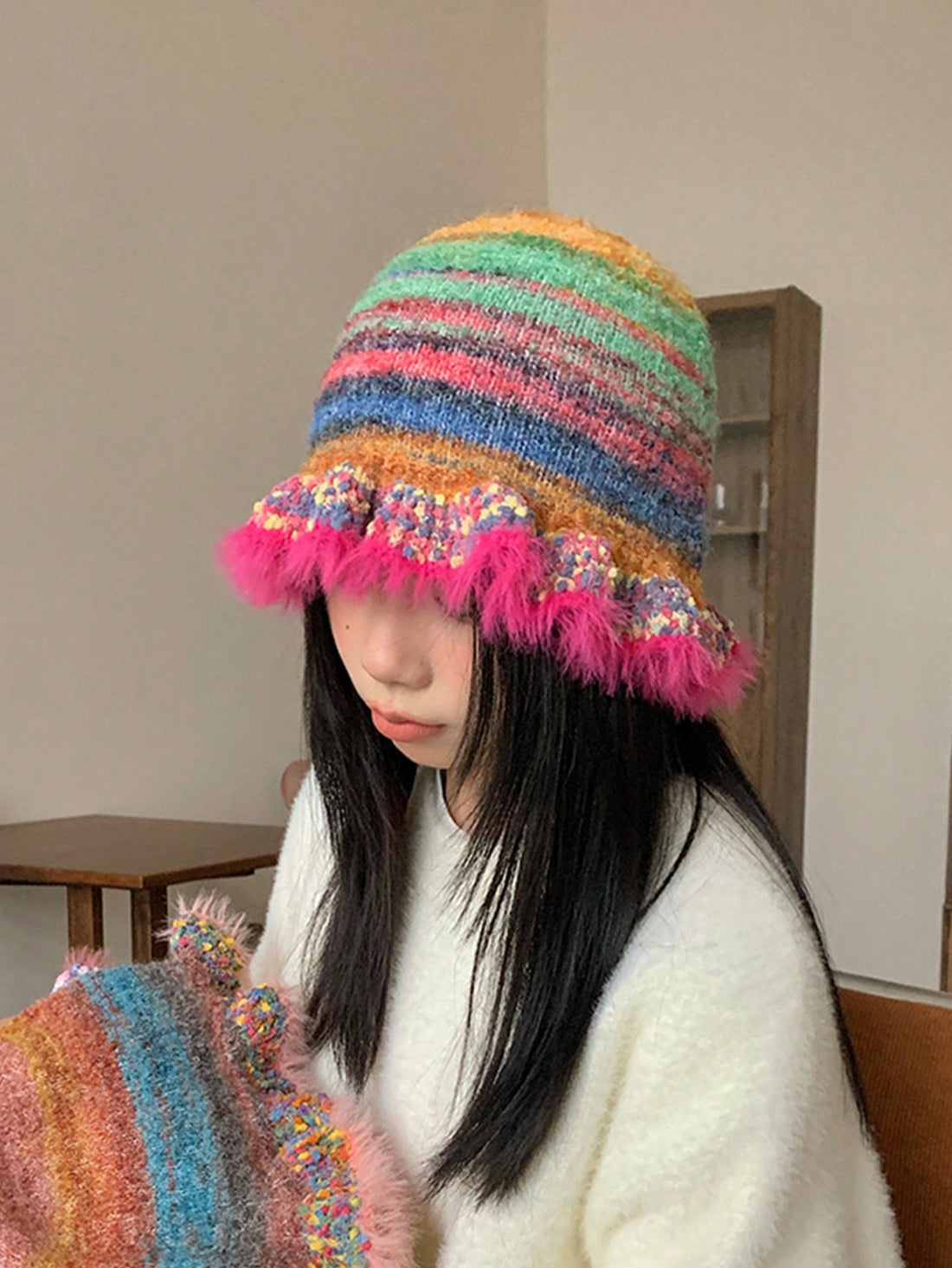 Introducing Boho Chic: Vintage Rainbow Stripe Woolen Hat with Ruffle Edge. Made with 100% wool, this hat features a vibrant rainbow stripe design and delicate ruffle edge for a unique and stylish look. Stay warm and on-trend this season with this must-have accessory.