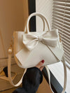 Introducing the must-have accessory for fashionable women - the Chic and Stylish Bow-Decor Handbag! With its elegant design and eye-catching bow decor, this handbag will elevate any outfit and make a statement. Stay stylish and on-trend with this must-have piece.