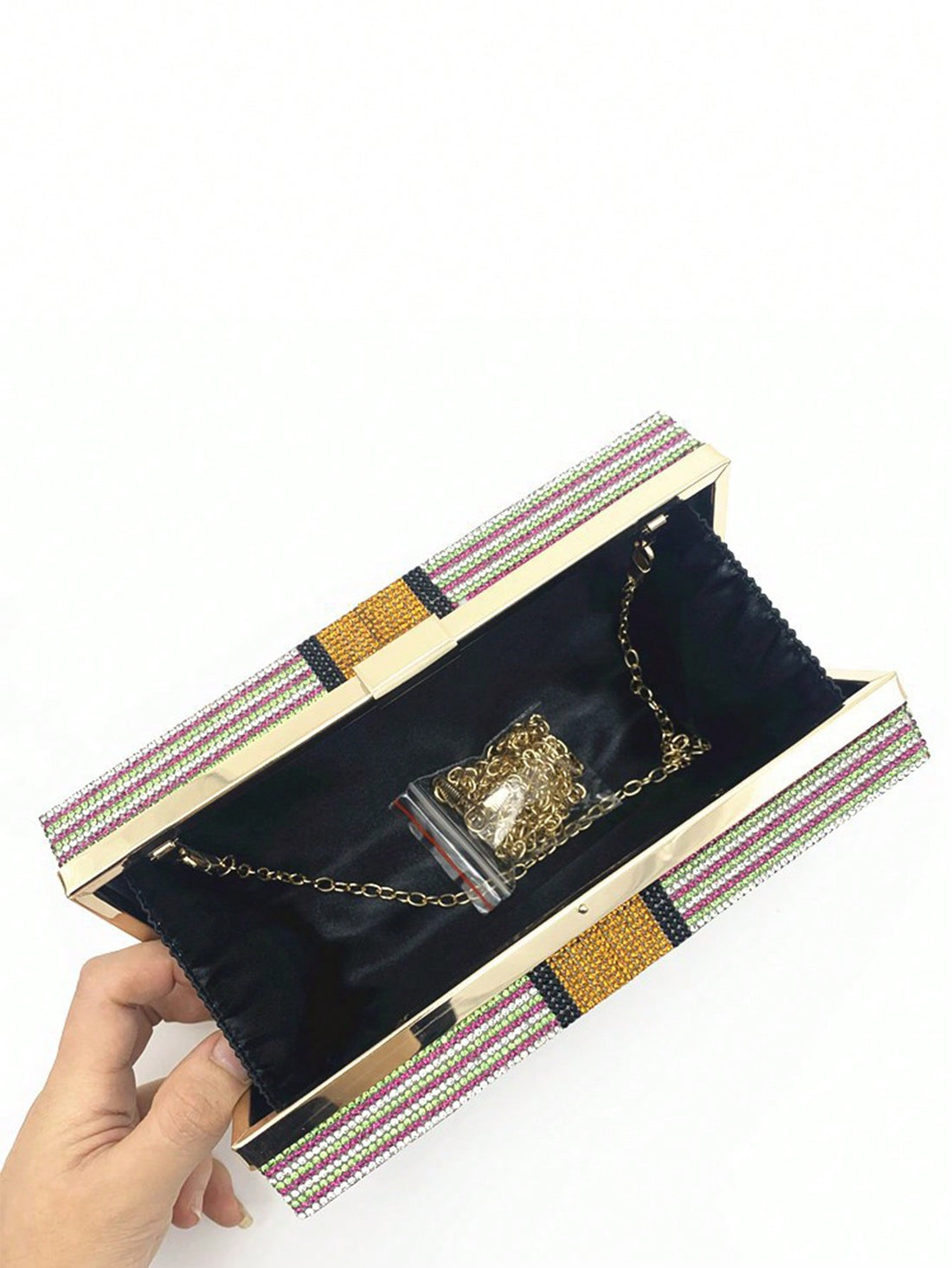 Introducing our Sparkle and Shine Rhinestone Dollar Evening Bag. Add glamour to any party with this dazzling crossbody clutch. Adorned with rhinestone dollar symbols, it's the perfect accessory for a night out. Make a statement and stand out while carrying all of your essentials in style.
