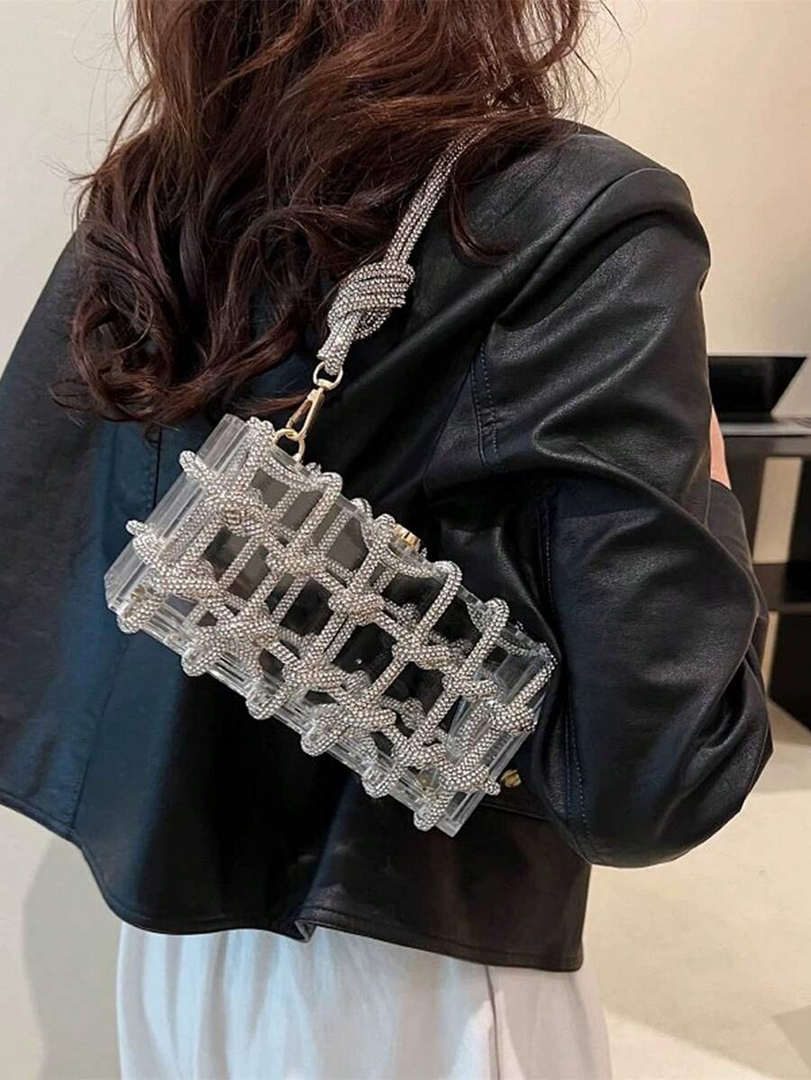 Turn heads at every party with this elegant acrylic clutch, sparkling with rhinestone embellishments that catch the light just right. Perfectly sized for your must-haves, it adds a dazzling touch to weddings and special occasions while keeping your essentials close in style. Ready to shine? This clutch is your new go-to glam companion.