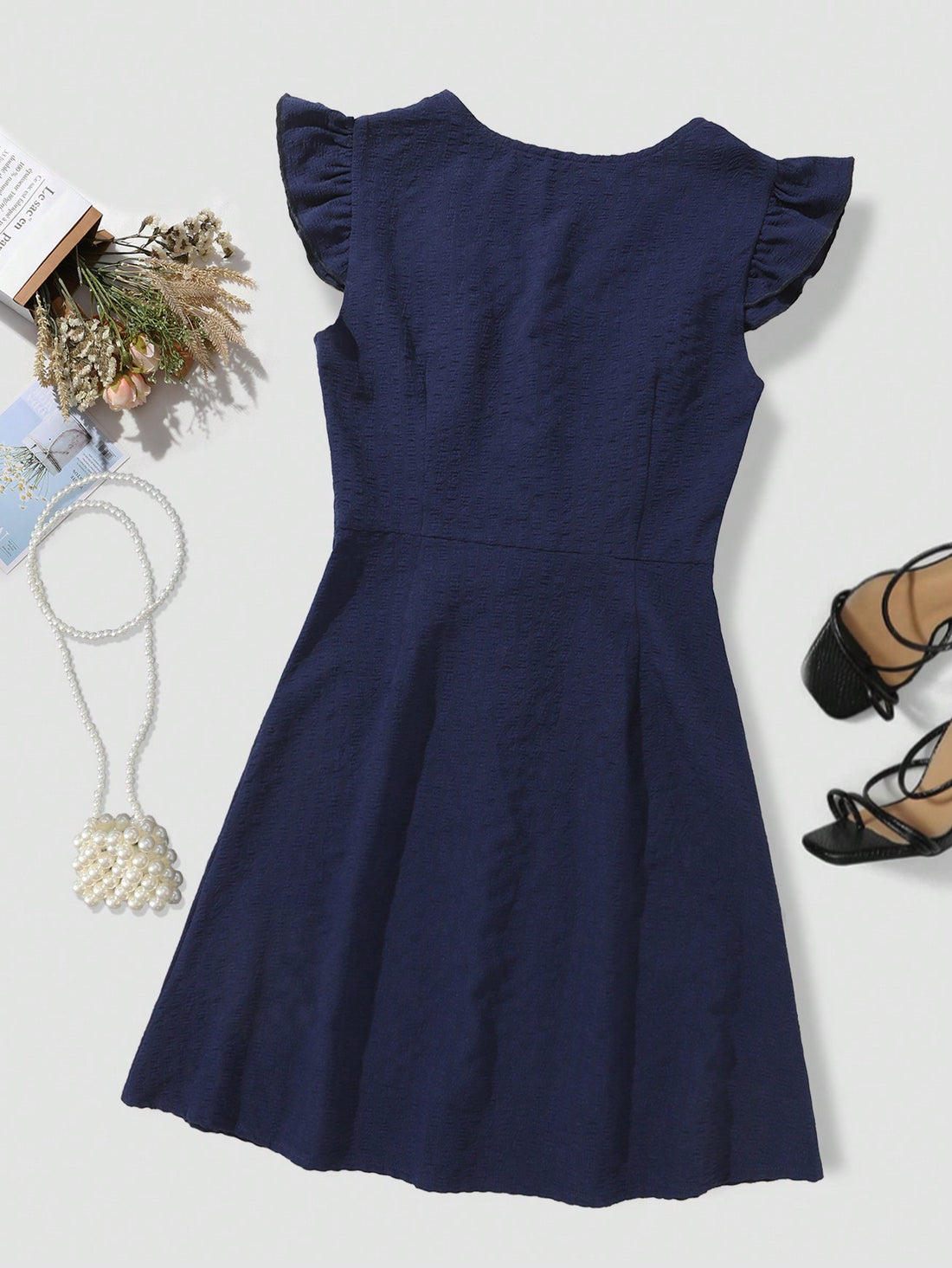 Add a touch of chic to your wardrobe with this elegant flutter sleeve dress! Featuring a deep V-neckline and front buttons, this dress is perfect for any occasion. (No more boring outfits!)