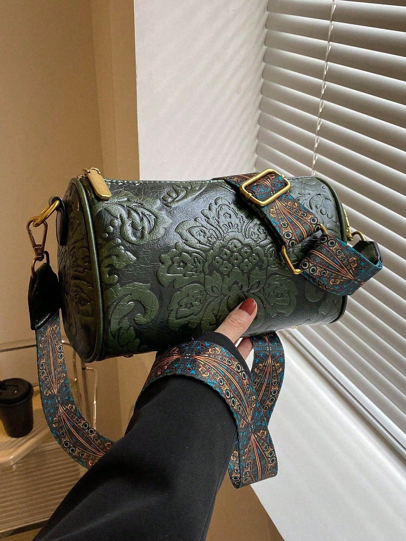 This crossbody bag for middle-aged women features a chic and stylish design with embossed flower details. It is perfect for adding a touch of elegance and sophistication to any outfit. With its functional crossbody strap, it allows for hands-free convenience while carrying essentials. Elevate your style with this timeless piece.