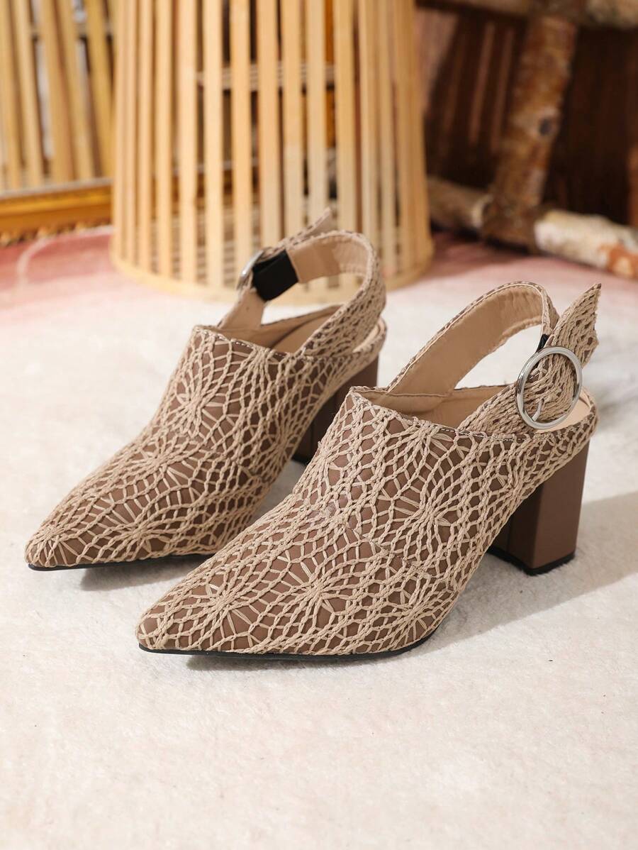 Front three-quarter view of taupe crochet pointed-toe pumps showing geometric openwork and block heels
