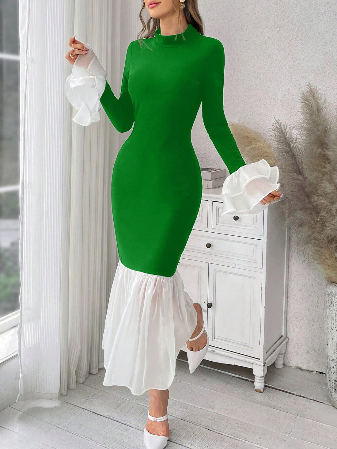 This dress features a playful fish print and chic colorblocking, making it the perfect choice for attending a wedding. The ruffle detail adds a touch of femininity and charm. Expertly crafted for a flattering fit, this dress is sure to make a statement at any special event.