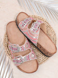 Pink boho flat sandals angled view with rhinestone embellishment