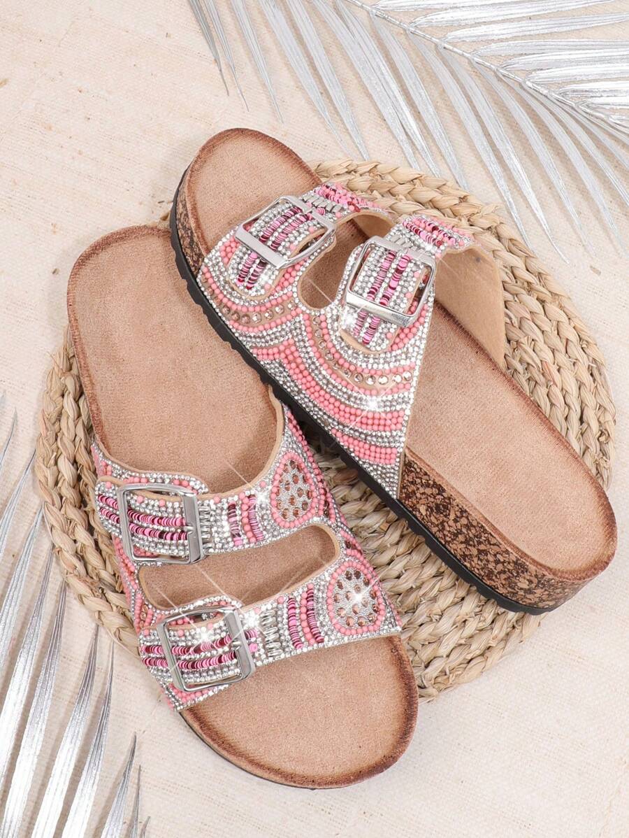 Pink boho flat sandals angled view with rhinestone embellishment