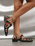 Side profile of floral print T-strap pumps with low block heels and stitched soles