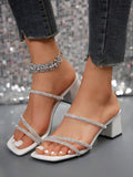 Front close view of white crystal strap mule sandals with square toe