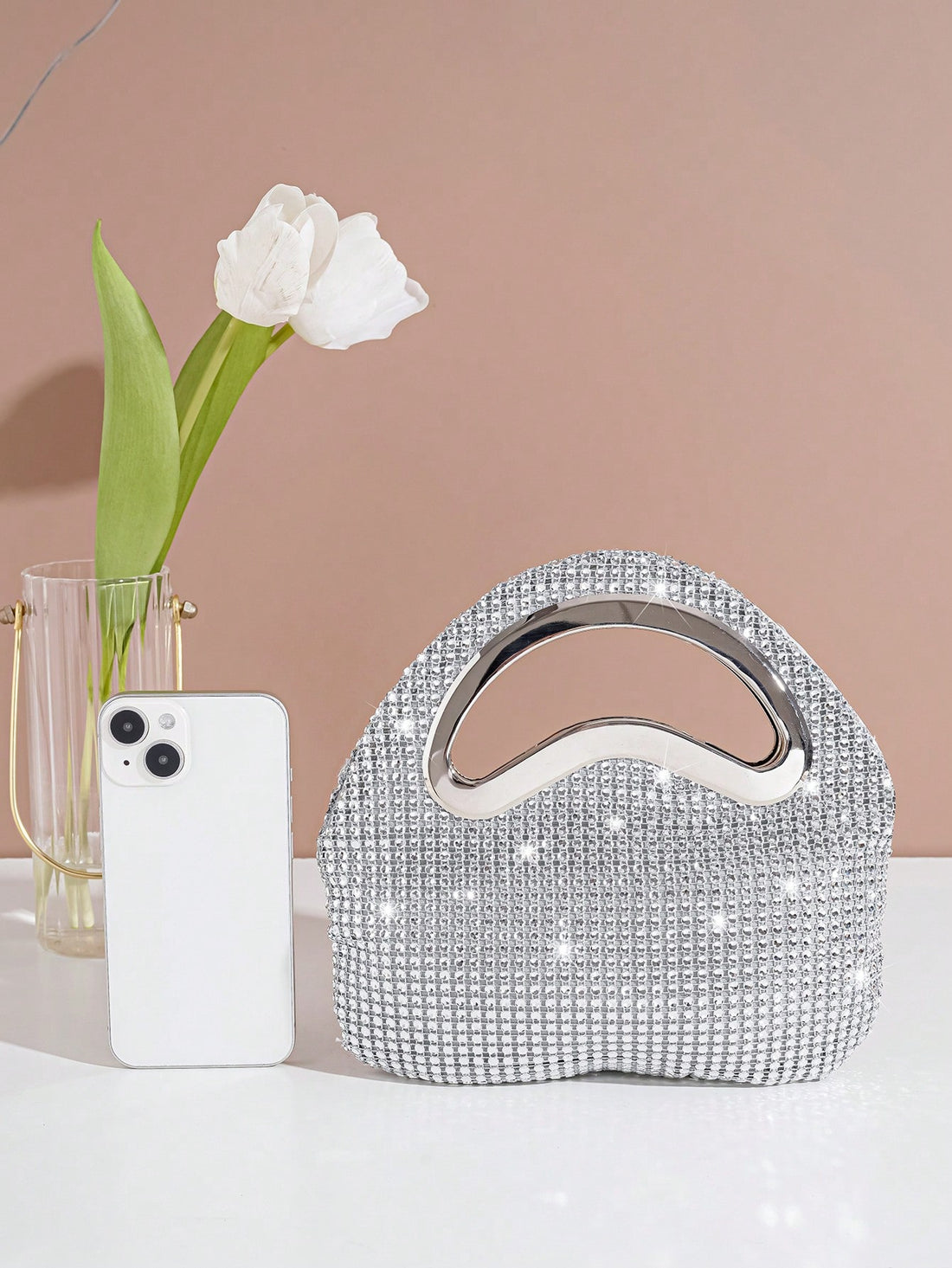 Get ready to make a statement with our stunning Sparkling Rhinestone Clutch! Perfect for glamorous nights out, this evening handbag adds a touch of luxury to any outfit. Its sparkling rhinestones will catch everyone's eye, making you feel like the star of the night. Elevate your style with this must-have accessory!