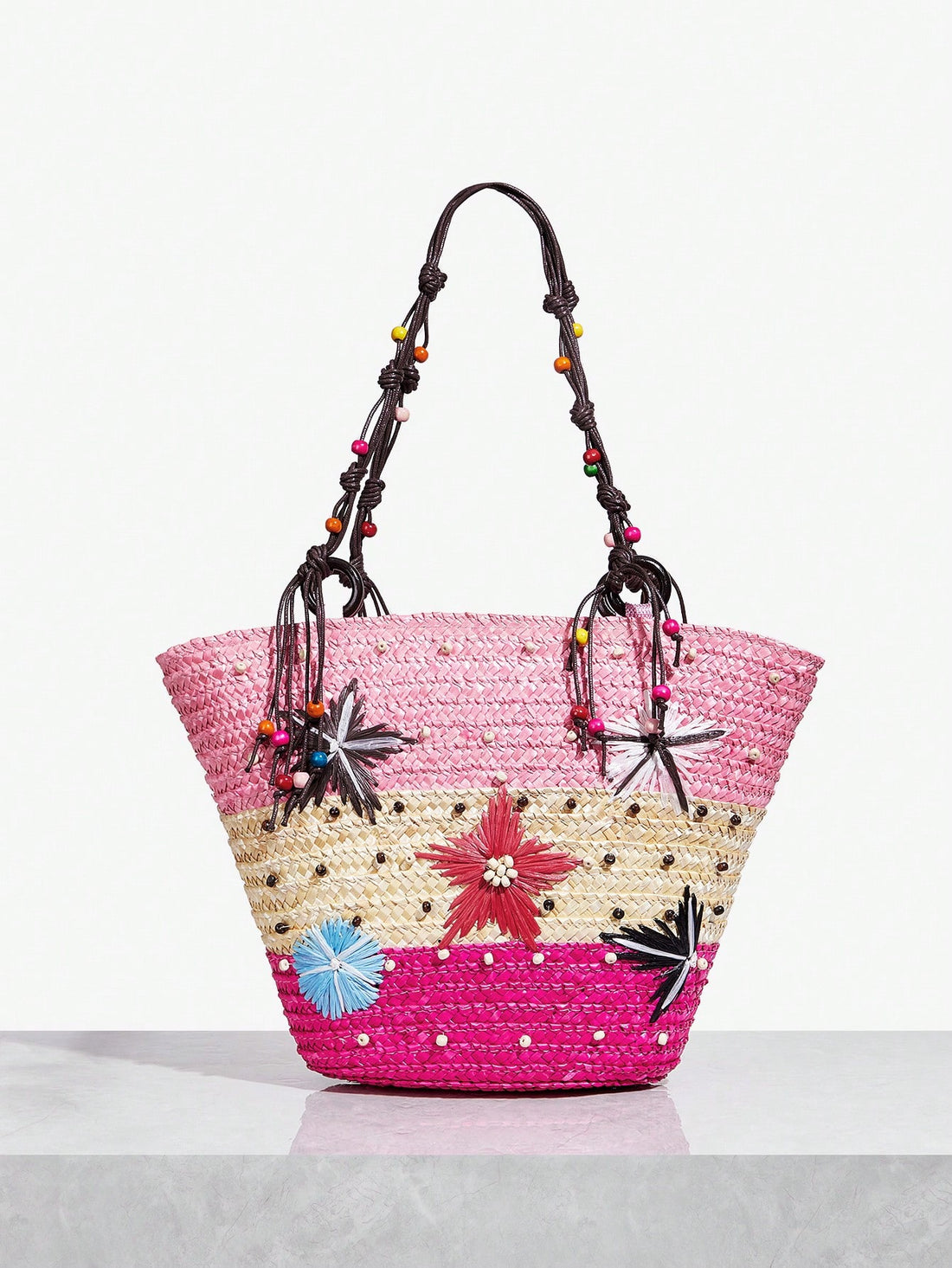 Stay stylish this summer with our Women's Multicolor Woven Tote Bag. Featuring a zippered closure, this bag is perfect for carrying all your essentials while adding a pop of color to your outfit. Stay organized and fashionable with this must-have summer accessory.