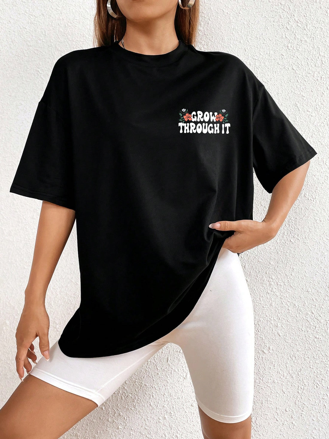 Introducing the Chic and Spooky: Floral Skeleton Print Drop Shoulder Tee. This t-shirt boasts a unique floral skeleton print, perfect for adding a touch of edge to any outfit. Its drop shoulder design offers a fashionable and comfortable fit. Get ready to stand out with this chic and spooky tee.