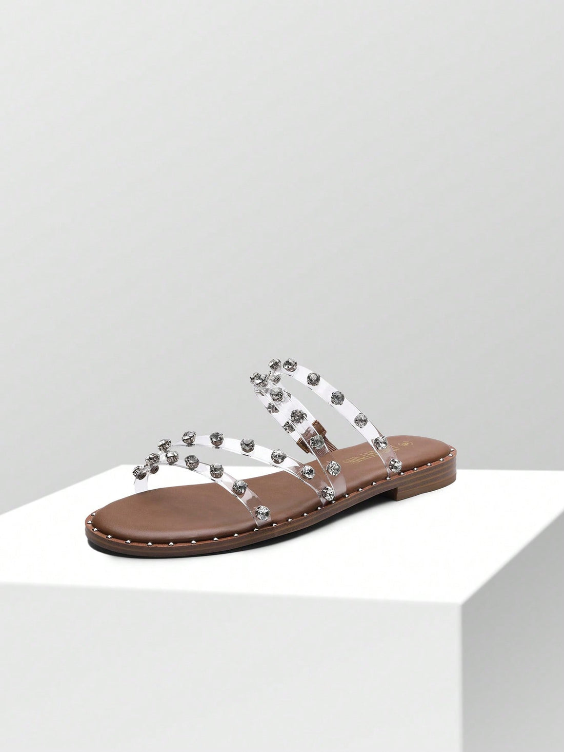 These slide <a href="https://canaryhouze.com/collections/women-canvas-shoes?sort_by=created-descending" target="_blank" rel="noopener">sandals</a> are a must-have for summer! The clear design is both stylish and versatile, making them perfect for any outfit. The studded rhinestones add a touch of elegance, while the comfortable fit ensures all-day wearability. Stay trendy and comfortable this summer with our cute and stylish slide sandals.