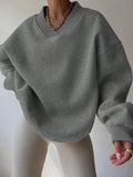 Front view of dark grey oversized V-neck sweatshirt with heathered finish