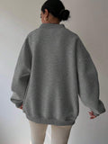 Back view of dark grey oversized sweatshirt with dropped shoulders and rib-knit trim