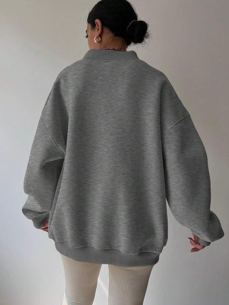 Back view of dark grey oversized sweatshirt with dropped shoulders and rib-knit trim