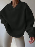 Front worn view of black oversized V-neck sweatshirt with dropped shoulders