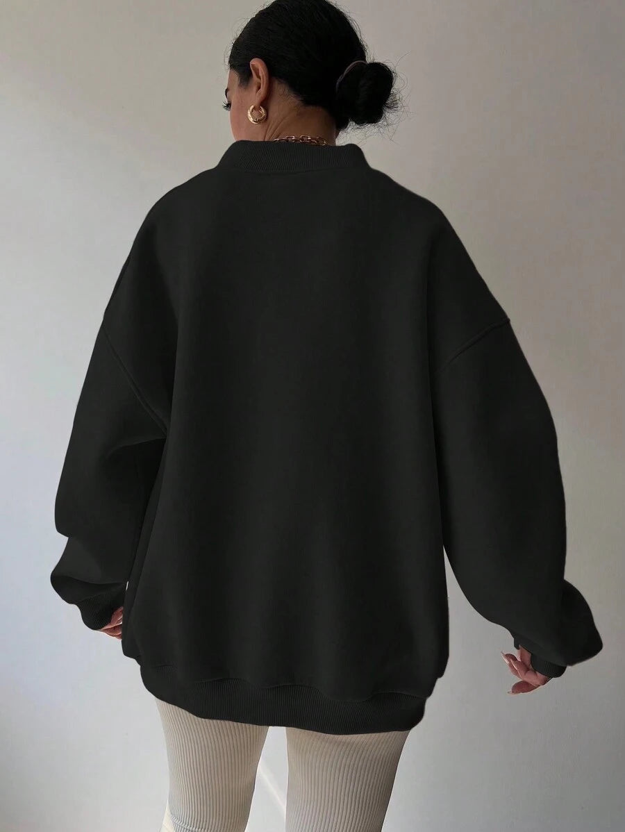 Back worn view of black oversized sweatshirt with wide rib-knit hem and cuffs
