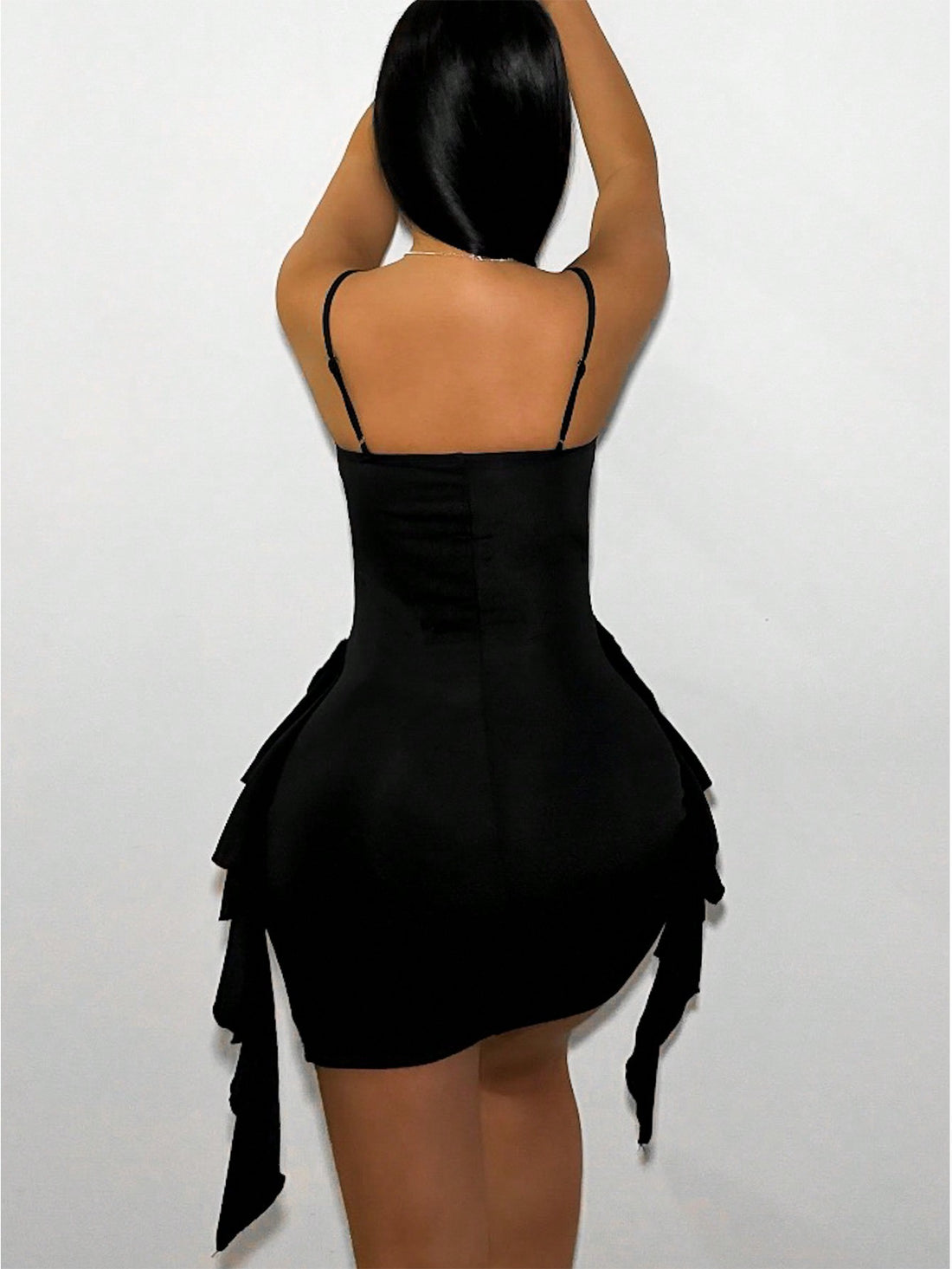 Turn heads in this flirty backless mini dress that's equal parts bold and beautiful. Delicate spaghetti straps frame the shoulders while the open back creates an undeniably chic moment. Playful ruffle trim adds texture and movement, making this piece perfect for nights out, parties, or whenever you want to feel confident and fabulous. Pair it with heels and minimal jewelry to let the dress do the talking.