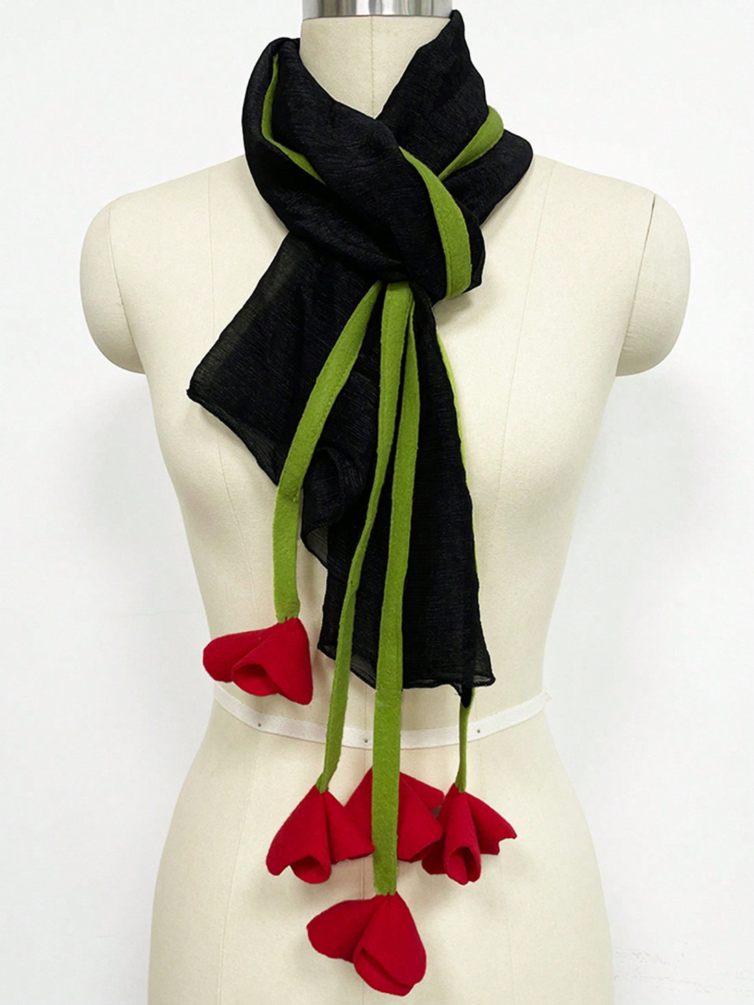 This black gauze scarf with simulated red blooms offers effortless style with a chic retro touch. Made from high-quality materials, this scarf adds a pop of color to any outfit while providing lightweight comfort. Perfect for any fashion-forward individual looking to elevate their wardrobe.
