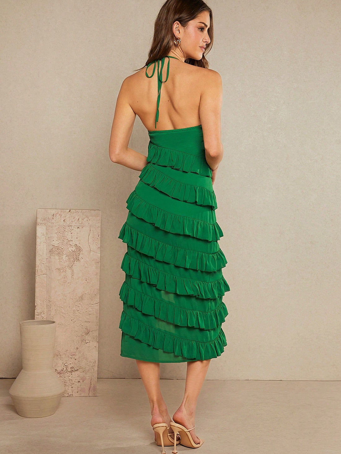 Step into summer with this playful tiered ruffle halter dress, designed for easy elegance. The split detail adds a flirty twist, while the tie halter neckline lets you adjust for the perfect fit. Lightweight and breezy, it’s your go-to for sunny days and spontaneous adventures.