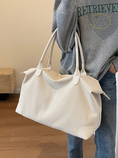 Experience chic and practical fashion with our Creamy Corduroy Chic tote bag! Made with a large capacity, it's perfect for carrying all your essentials. The creamy corduroy design adds a stylish touch, while the spacious interior and sturdy straps provide convenience and durability.