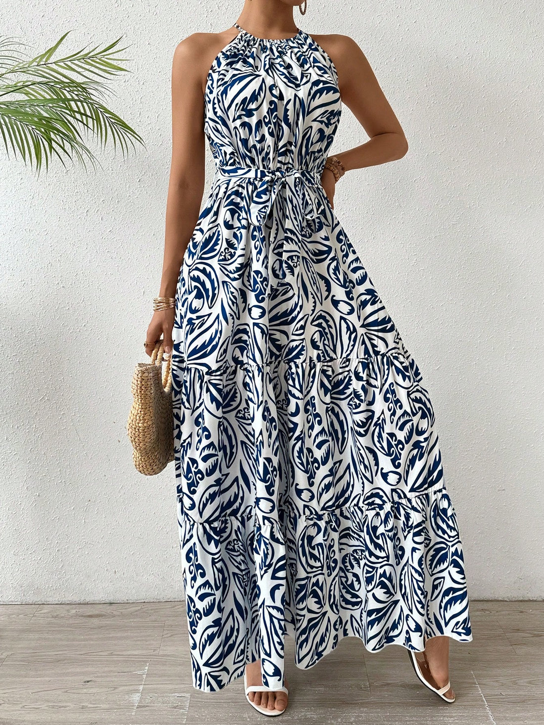 Experience effortless beach elegance with Floral Dream: Plant-Printed Halterneck Maxi Dress. The vibrant plant print and halterneck style combine for a stunning look. Perfect for any beach day or summer event. Let this dress take you away on a floral dream.