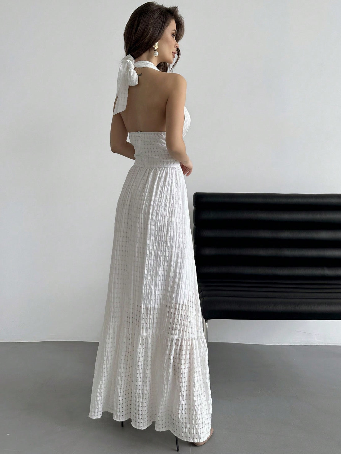 Turn heads this season in our stunning halter neck plaid dress, where timeless pattern meets modern flair. The flattering halter design frames your shoulders beautifully, while the playful ruffle hemline adds movement and charm to every step. Crafted in crisp white, this versatile piece transitions effortlessly from graduation celebrations to summer dates and beyond. Whether you're dressing up for a special occasion or elevating your everyday style, this dress delivers that perfect balance of sophistication