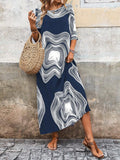 Outdoor styling of navy graphic maxi dress with straw bag and sandals