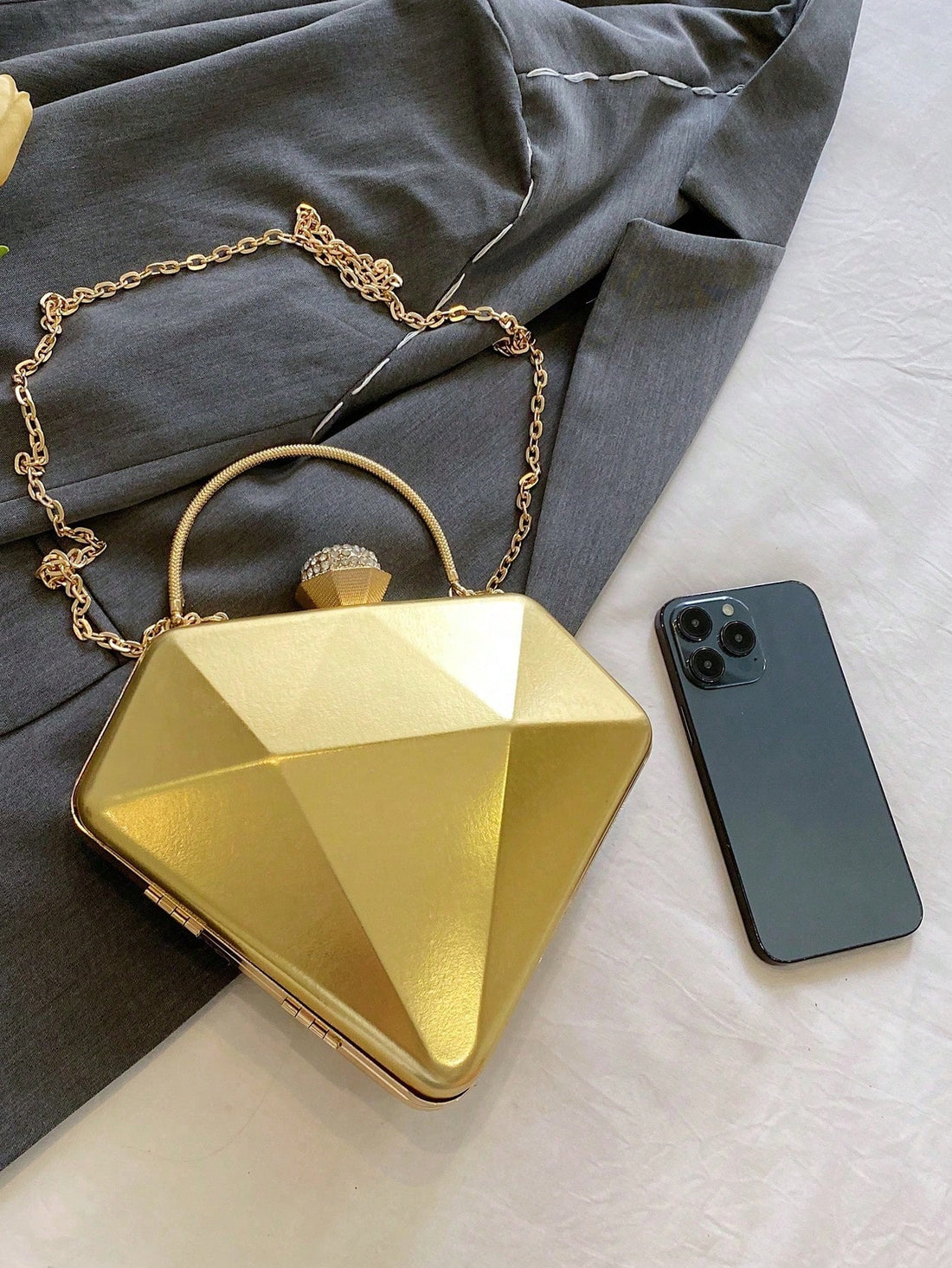 Introducing our Diamond-Shaped Rhinestone Clutch - a stunning evening purse for trendy women with a steampunk-inspired design. This clutch is both stylish and functional, adding a touch of elegance to any outfit. With rhinestone accents and a unique diamond shape, it's perfect for any special occasion. Elevate your style with this must-have accessory!