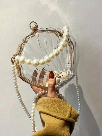 Elevate your style with our 2024 Women's Shell Shaped Clutch. This chic acrylic handbag is perfect for the beach, sports, and picnics. Its unique design and durable material make it a versatile accessory for any occasion. Add this must-have piece to your collection today.