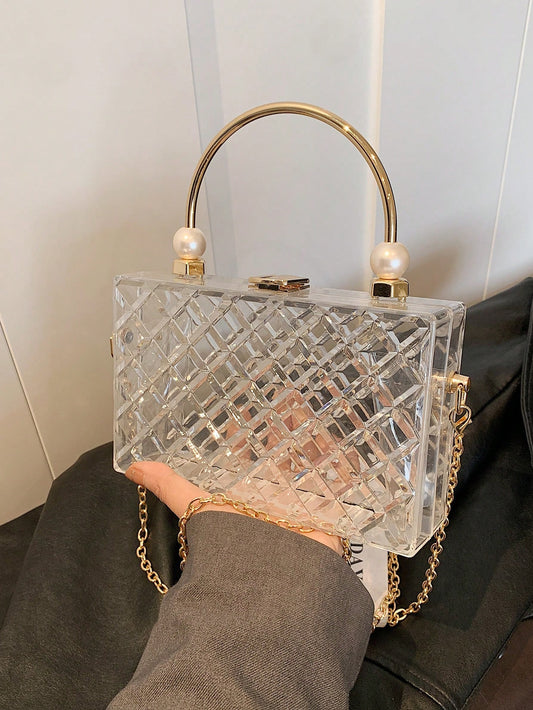 Experience luxury and elegance with our Crystal Clarity Dinner Bag. Made from high-end, transparent acrylic, this bag features a pearl handbag design, perfect for formal events. Carry all your essentials while making a statement with this stylish and modern piece.