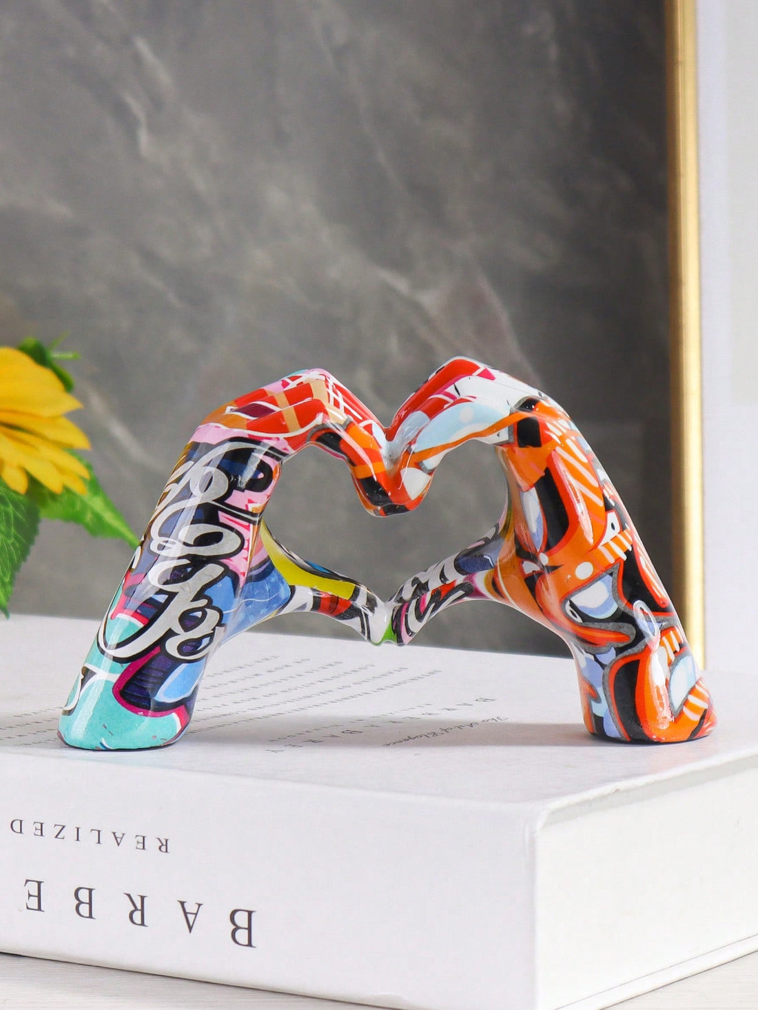 Brighten up any room with our Vibrant Resin Love Gesture Ornament. Made from durable resin, this colorful piece adds a touch of love and personality to your decor. Perfect for a pop of color or a thoughtful gift for a loved one. Let it serve as a reminder to spread love and joy in your home.