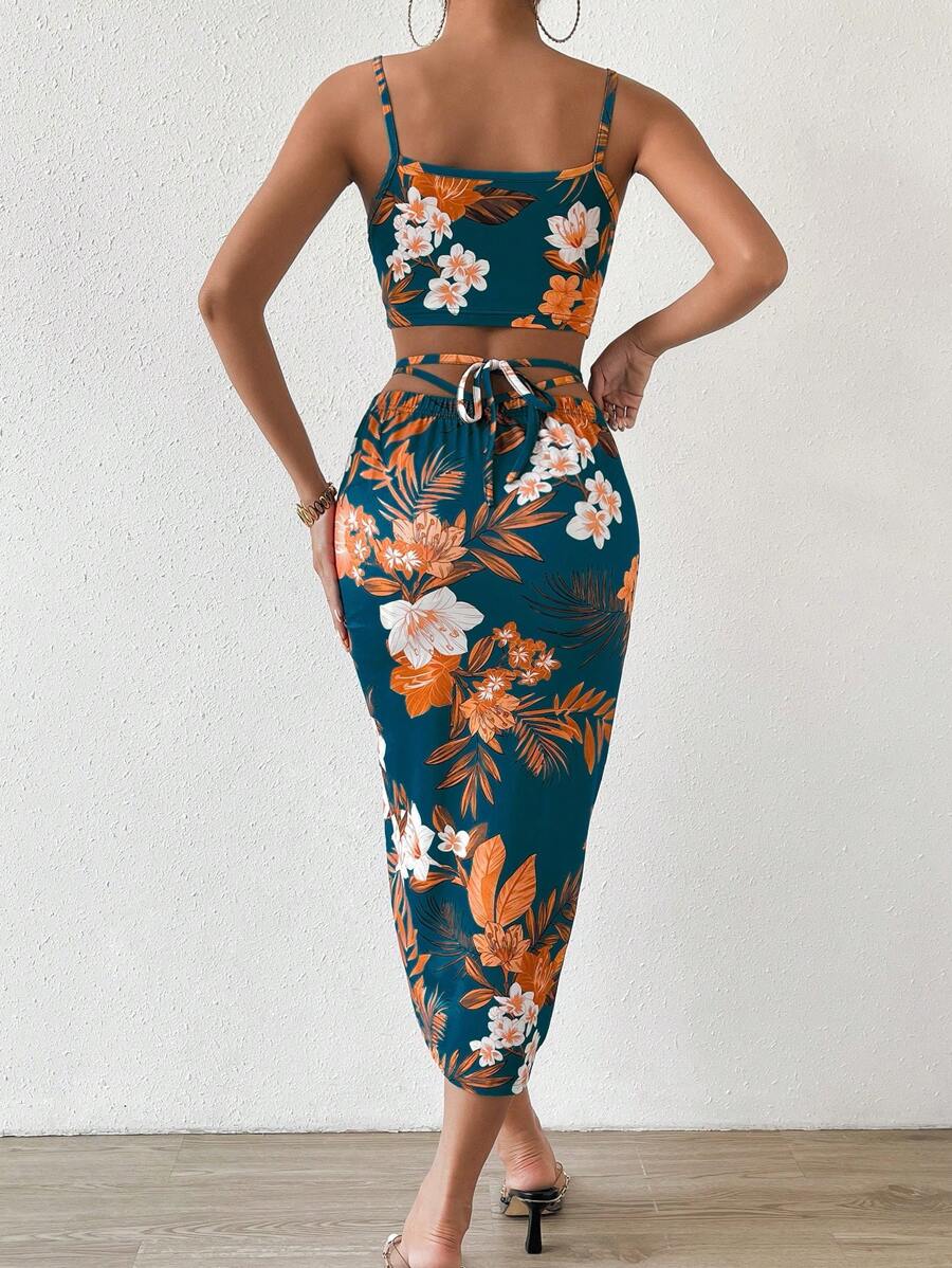 Back view of floral tie-back crop top and fitted ruched midi skirt resort outfit