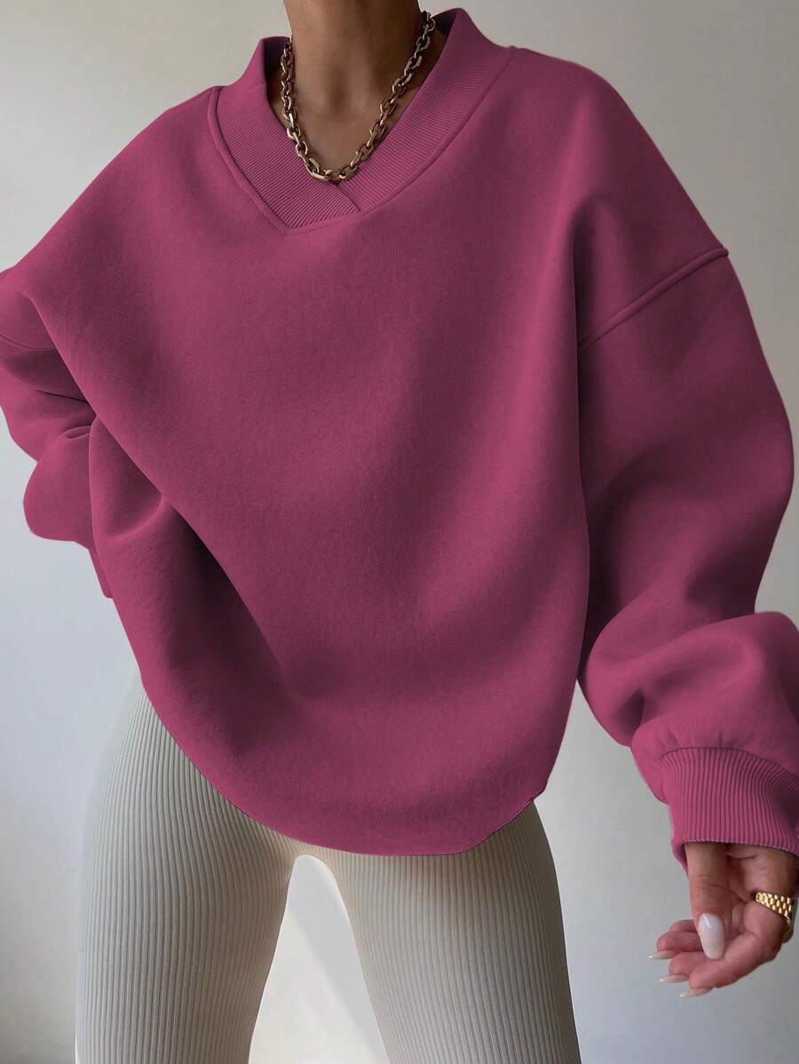 Front view of red violet oversized V-neck sweatshirt with loose long sleeves