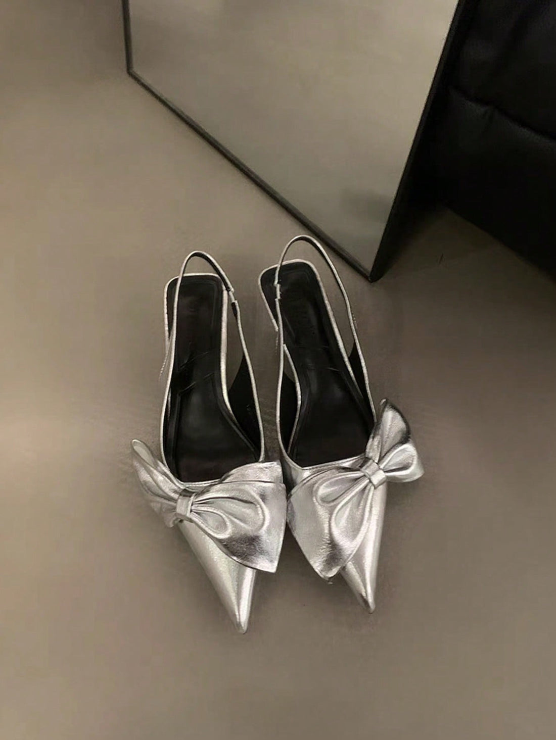 Elevate your style with these Stunning Silver Stiletto Sandals. Designed in the European & American Style, these high heels feature a striking bow detail. Walk with confidence and sophistication thanks to the sturdy stiletto heel. Perfect for any special occasion, these sandals will surely make a statement.