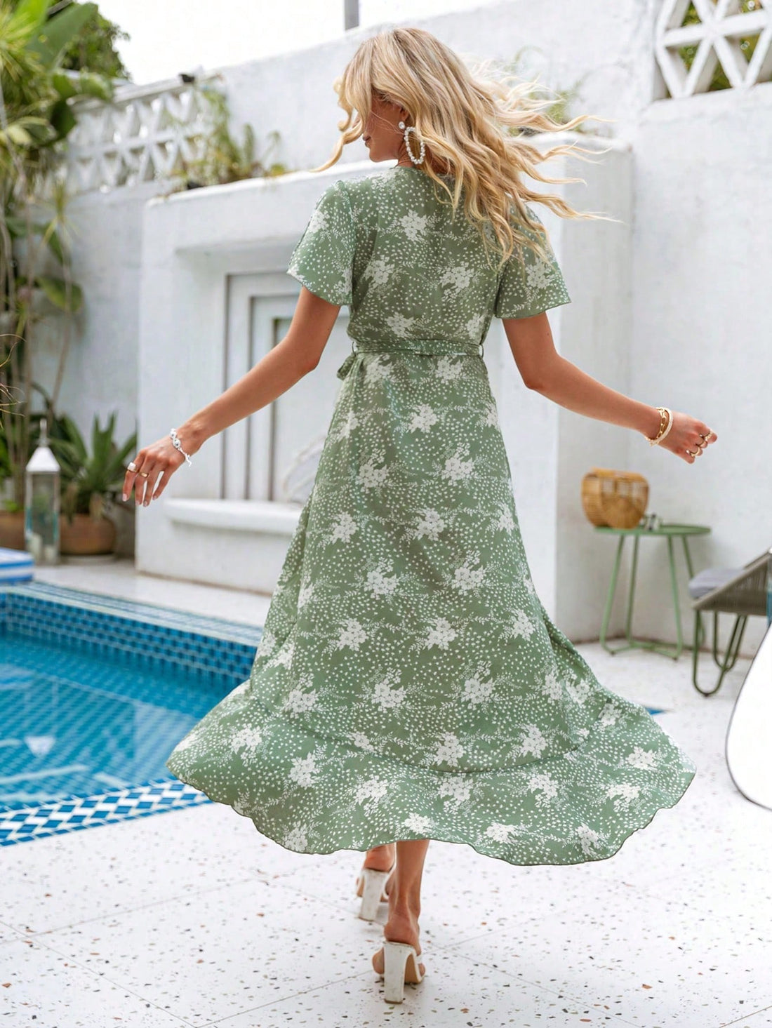 Experience effortless elegance in our Floral Elegance dress. With a simple slit design and beautiful ruffle wrap detail, this dress is both feminine and sophisticated. The bell sleeves add a touch of whimsy, making it perfect for any occasion. Embrace your style with Floral Elegance.