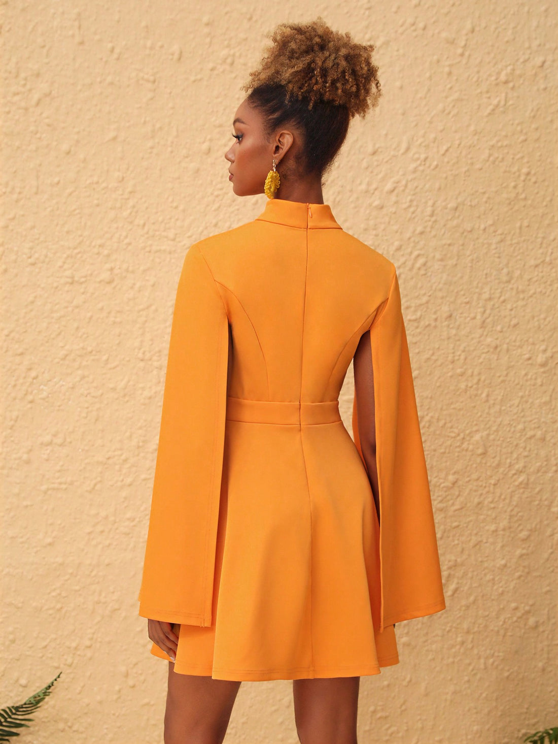 Introducing Enchanted Elegance: High Neck Mini Dress with Cloak Sleeves. This stunning dress features a high neck and unique cloak sleeves, adding a touch of elegance to any outfit. Made with high-quality materials for both comfort and style, this dress is sure to make you stand out from the crowd. Perfect for any formal occasion or a night out on the town.