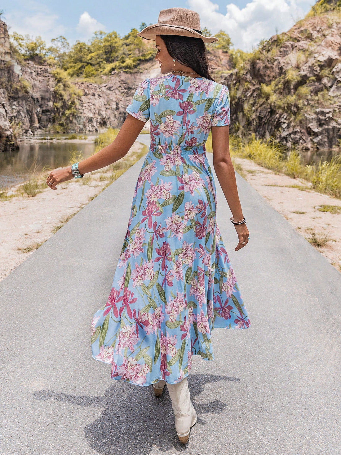This high-waisted slit dress features a vibrant floral print, perfect for the spring season. With its bold colors and flattering silhouette, this dress is sure to make a statement. Elevate your style with this must-have addition to your wardrobe.