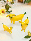 Add a touch of whimsy to your workspace with our hand-painted resin Whimsical Banana Dog Desk <a href="https://canaryhouze.com/collections/ornaments" target="_blank" rel="noopener">Ornament</a>. This playful decoration is sure to bring a smile to your face every time you glance at it. Perfect for dog lovers and anyone looking to add a bit of fun to their desk.