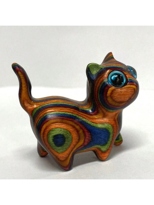 This whimsical wooden cat model is a unique and thoughtful pet memorial toy or <a href="https://canaryhouze.com/collections/ornaments" target="_blank" rel="noopener">birthday surprise gift</a>. Individually hand-carved and adorned with vibrant rainbow colors, it serves as a charming reminder of your beloved pet or a one-of-a-kind present for any cat lover.