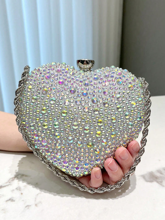 Add a touch of elegance to any special occasion with our Dazzling Diamond Heart Evening Bag. Perfect for parties, weddings, and more, this stunning bag is sure to make a statement. Its intricate design and sparkling diamonds will have you dazzling all night long. Elevate your style with this must-have accessory.