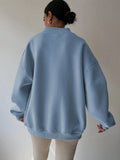 Back view of baby blue oversized sweatshirt with dropped shoulders and rib-knit hem