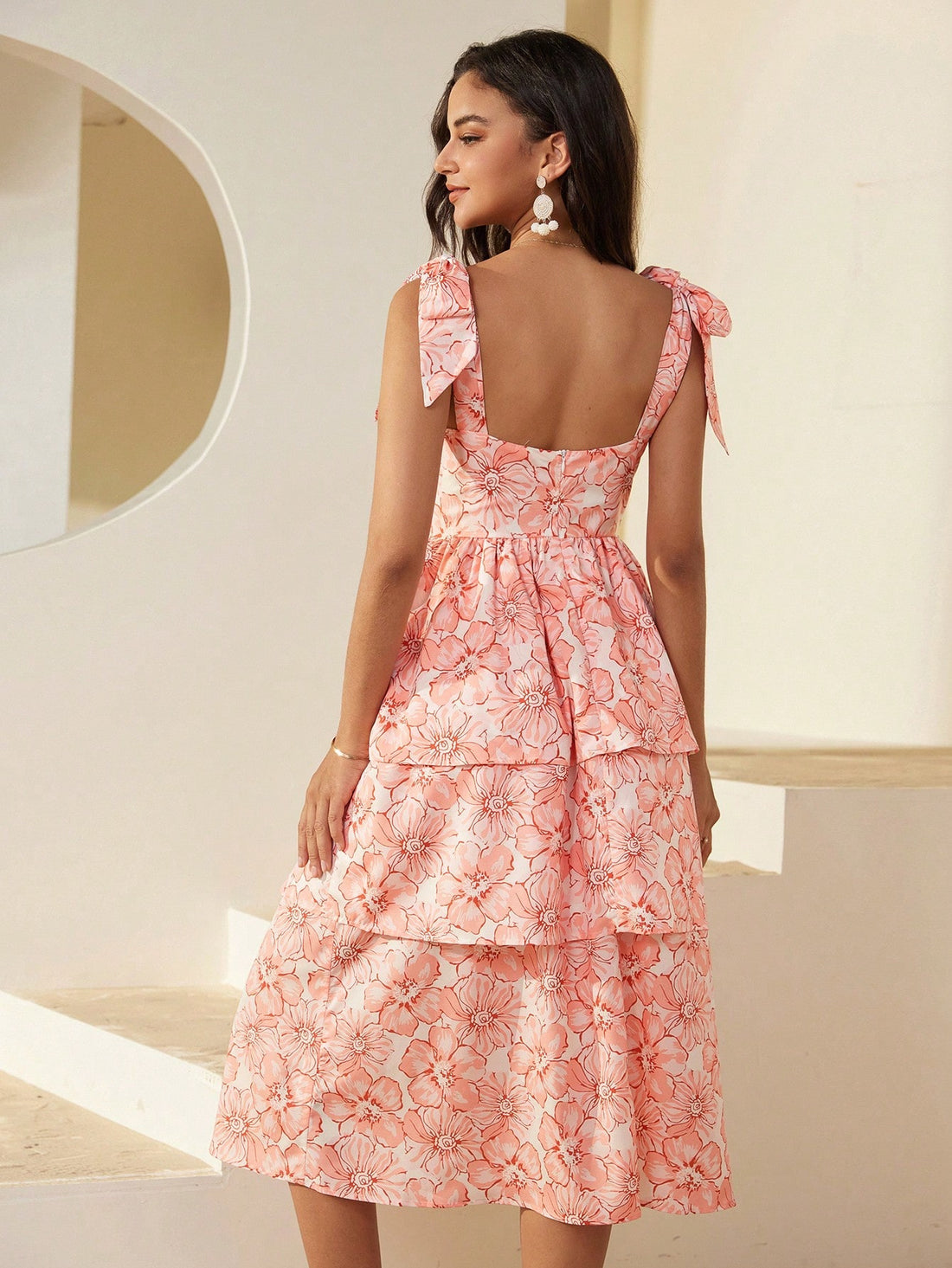 Enjoy the perfect blend of style and comfort with our Floral Bliss Maxi Dress. The cami strap design and bowknot detail add a playful touch, while the lightweight fabric is perfect for a sunny day at the beach. Elevate your vacation wardrobe with this must-have dress.