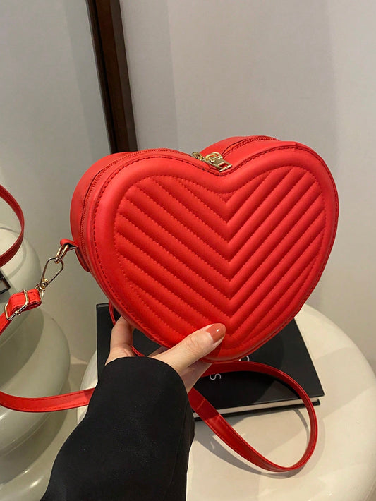 This romantic heart-shaped crossbody bag features a unique V-shaped embossed pattern, making it a stylish accessory for any woman. With its compact size and adjustable strap, it's the perfect bag for everyday use or a night out. Give your outfit a romantic touch with this must-have accessory.