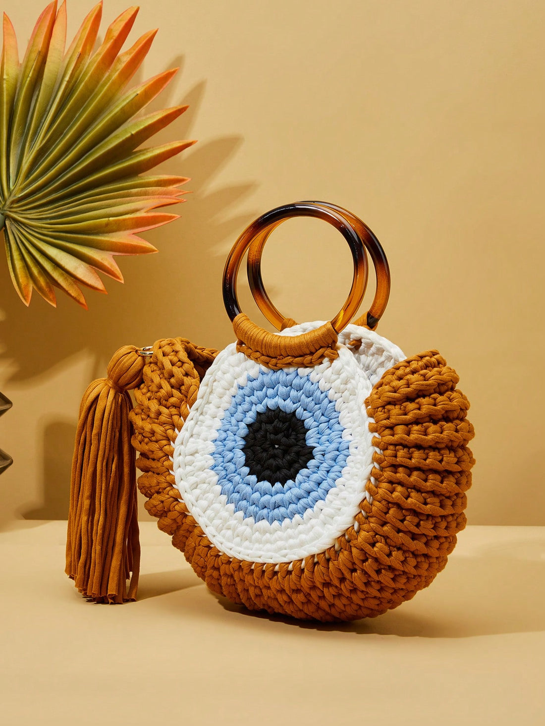 This beach bag combines whimsy and practicality, featuring a cute cartoon monster design and functional tassel closure. The woven texture adds durability for all your beach essentials. Perfect for a fun day in the sun with added style and ease.